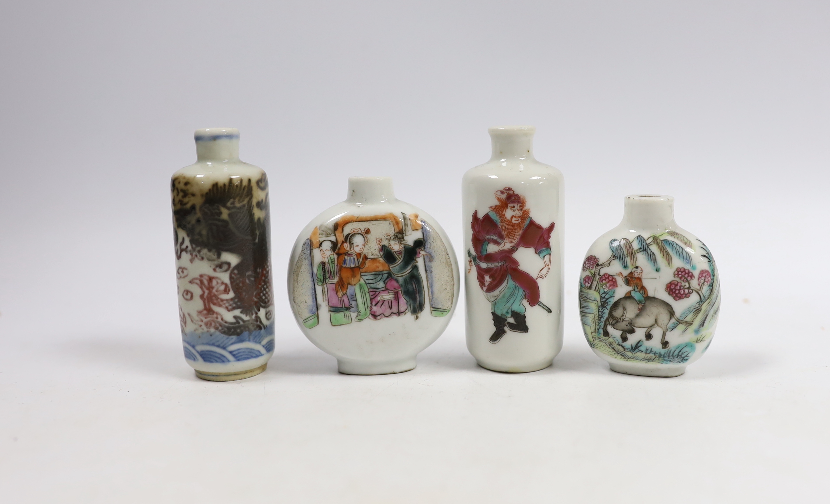 Three 19th century Chinese famille rose snuff bottles, and an underglaze copper red ‘Dragon’ snuff bottle, tallest 9cm